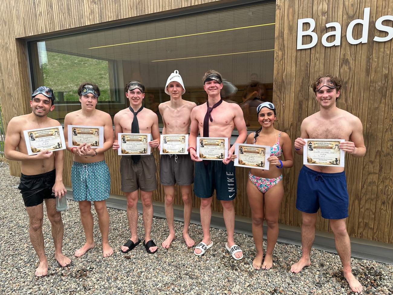 All participants outside the sauna with their certificates
